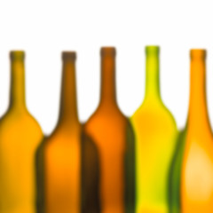 GROUP OF FIVE GREEN AND BROWN WINE BOTTLES ON WHITE BACKGROUND