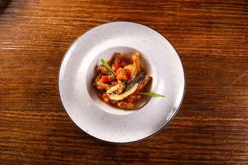 frog legs plate on black background 