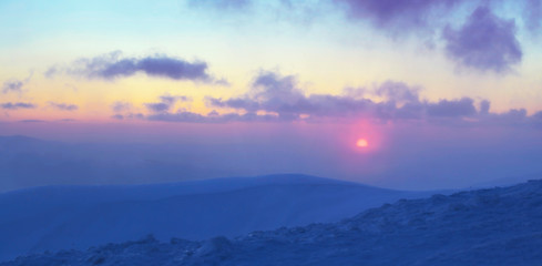 Fototapeta na wymiar sunset over mountain top, winter mountain range panorama