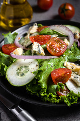 Fresh green salad with blue cheese, onions and cherry tomatoes