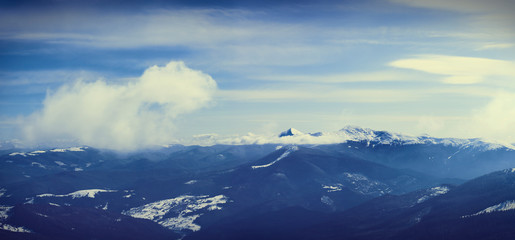 big snow mountain range top above clouds