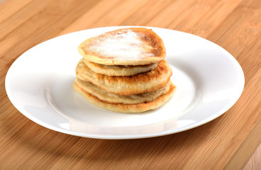 Oat pancakes with powdered sugar on top