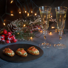 set of canapés for holiday catering menu for individual event fourshetes receptions buffet with meat, fish, salmon, seafood, scallops, turkey, hand and champagne in tall glasses
