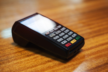 Payment terminal lying on a wooden table