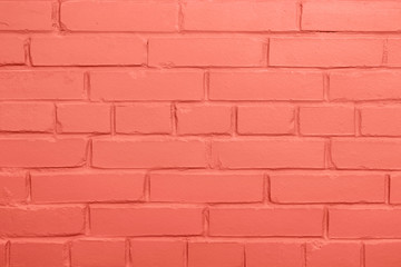Living Coral pantone brick wall background, copy space.