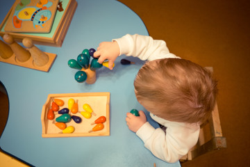 a little boy in the classroom for the early development of children's motor skills, psychological state of preparation for kindergarten 