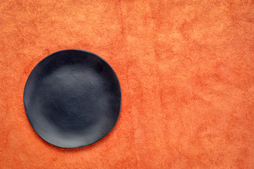 black plate on textured paper