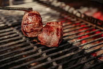 A top sirloin steak flame broiled on a barbecue, shallow depth of field.