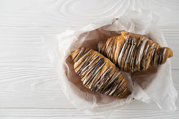 Overhead shot of freshly baked croissants with coffee