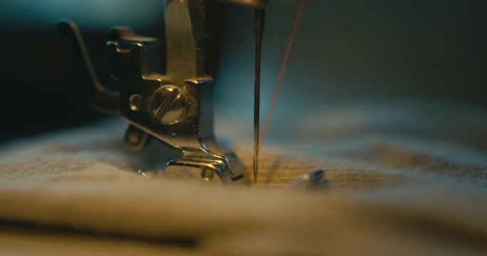 Close up on sewing machine needle at work