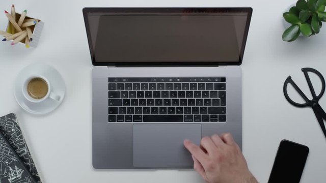 Male hands typing laptop on white clean minimalistic table with top view, gestures and finger movements