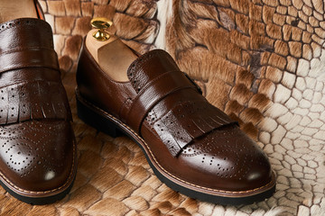 Leather men's shoes on fur background. close up