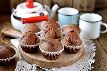 Homemade chocolate muffins. Homemade baking. Rustik style, wooden background.