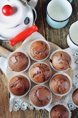 Homemade chocolate muffins. Homemade baking. Rustik style, wooden background.
