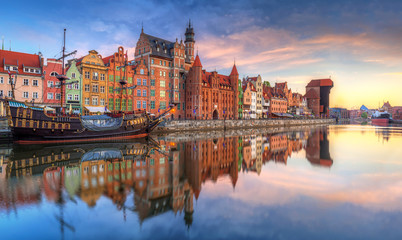 Naklejka na ściany i meble Beautiful old town of Gdansk reflected in Motlawa river at sunrise, Poland.