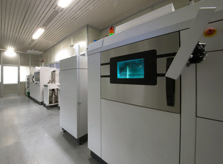 Fototapeta na wymiar Metal 3D printer (DMLS) - Direct metal laser sintering (DMLS) is an additive manufacturing technique that uses a laser fired into a bed of powdered metal.