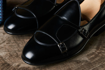 Tie and a Pair of man's classic leather shoes on wooden stump