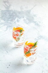 Alcoholic cocktail with grapefruit, soda, ice, gin and rosemary