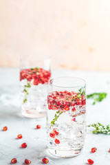 Festive drinks, gin and tonic pomegranate cocktail or detox water with ice