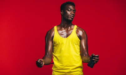 Fit young man with jumping rope