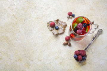 Fototapeta na wymiar Tea with berry and silver spoon