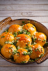 Garlic bread, buns. Bread rolls with garlic and parsley. vertical