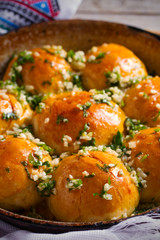Garlic bread, buns. Bread rolls with garlic and parsley. vertical