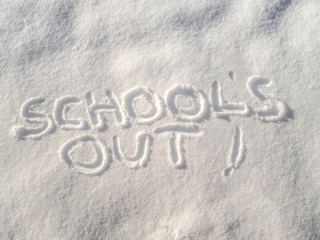 "School's Out!" written in freshly fallen snow with copy space.