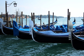 Fototapeta na wymiar Close-up view of beautiful traditional gondolas on Riva degli Schiavoni, promenade in Venice, Italy.