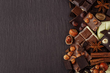 Chocolate on dark stone background. Top view with copy space