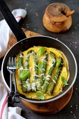 Frittata with asparagus and cheese. Healthy breakfast. Fried eggs with asparagus baked in the oven.