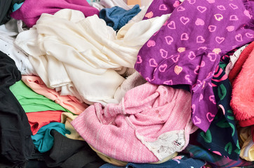 Pile of clothes of different colours in a mess