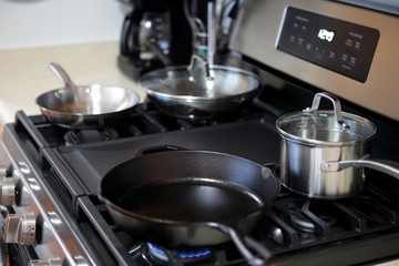 Cast iron pan heating up on gas range stove.