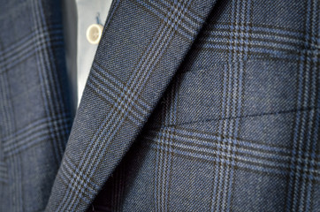 Close up of dark blue checked suit with lapels fragment