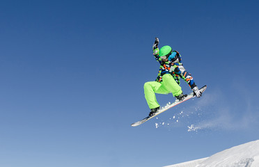 Fototapeta na wymiar First plane of a snowboarder jumping in a sunny day in Aspen ski resort, United States