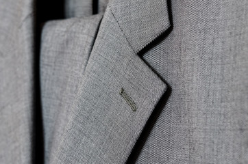 Close up of light grey woolen suit. Selective focus