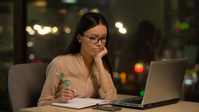 Young woman pondering over startup idea, lacking motivation and inspiration
