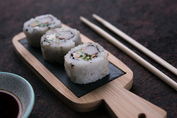 table with sushi and chopsticks with bowl of soy sauce