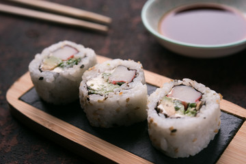 table with sushi and chopsticks with bowl of soy sauce