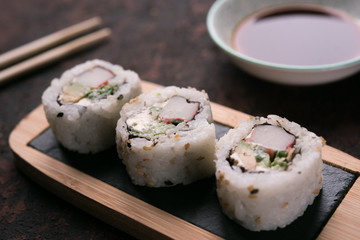 table with sushi and chopsticks with bowl of soy sauce