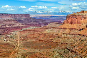 Looking Down the Sandstone Gorge Towards The Mountains in Canyonlands National Park of Utah