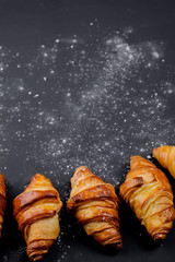 fresh croissants on a black background