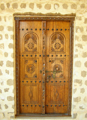 old ornate wooden door with beautiful carvings in United Arab Emirates.