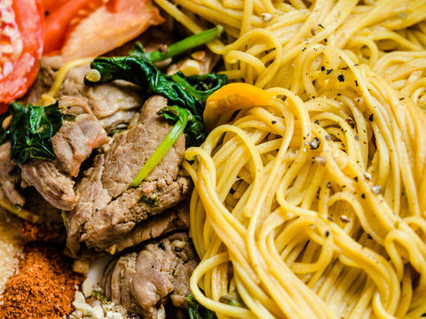 Chinese stir-fried rice noodles or shou mian with vegetable, fried Hong Kong noodles topped with pork (shou mian Chinese name menu)