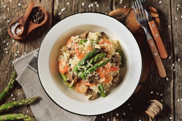 Italian risotto with shrimps, mushrooms, asparagus and parmesan. Healthy food.