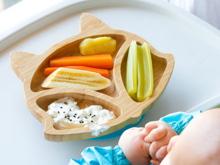 Baby eating by hands, Baby eating organic bio vegetables with BLW method, baby led weaning. Happy...