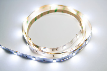 Modern glowing white twisted LED strip. Diodes emit warm white light.