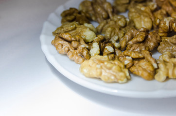 Pieces of walnuts on the white plate