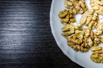 Pieces of walnuts on the white plate