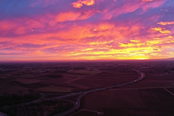 fiery sanset from drone. view from above. unbelievably beautiful sunset. clouds are highlighted in pink, purple and yellow-orange colors